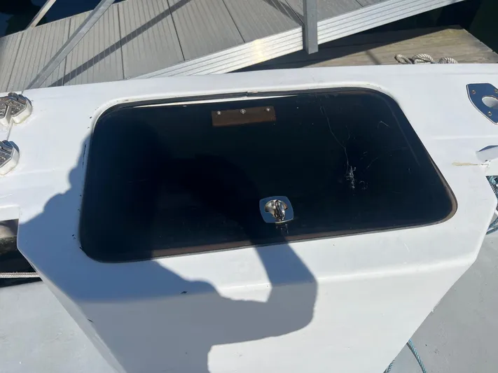  Yacht Photos Pics H&H Marine 42 Downeast 2003 boat hatch with shadow and dock background.