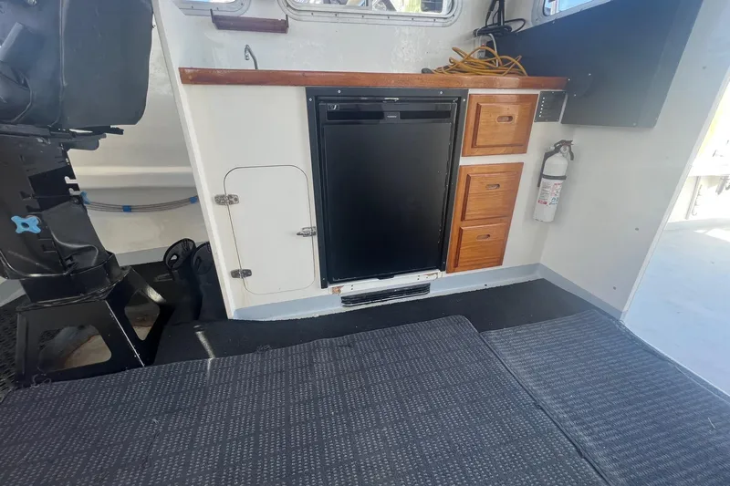  Yacht Photos Pics Interior of a 2003 H&H Marine 42 Downeast boat with fridge and storage cabinets.