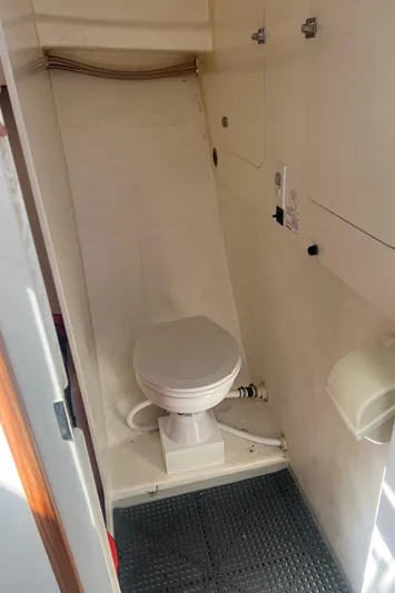  Yacht Photos Pics 2003 H&H Marine 42 Downeast boat bathroom with toilet and storage cabinets.