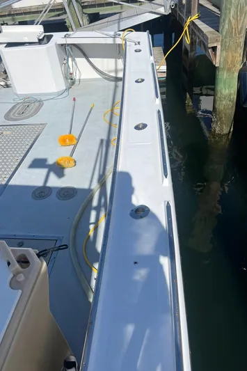  Yacht Photos Pics 2003 H&H Marine 42 Downeast boat deck with fishing gear and dockside view.