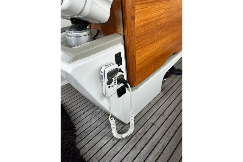 Cruzeiro Do Sul Yacht Photos Pics VHF radio on Jeanneau Sun Odyssey 44 DS yacht, 2013 model, with wooden paneling.