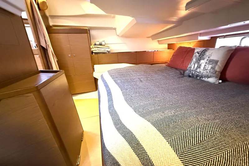 Cruzeiro Do Sul Yacht Photos Pics Interior of 2013 Jeanneau Sun Odyssey 44 DS yacht, featuring cozy cabin with bed and storage.