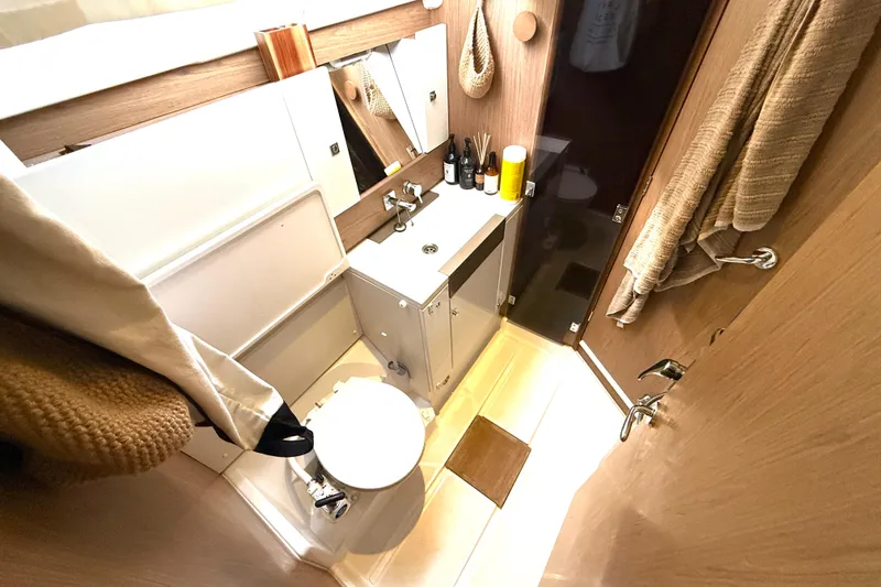 Cruzeiro Do Sul Yacht Photos Pics Bathroom interior of 2013 Jeanneau Sun Odyssey 44 DS yacht, featuring modern fixtures and wooden accents.