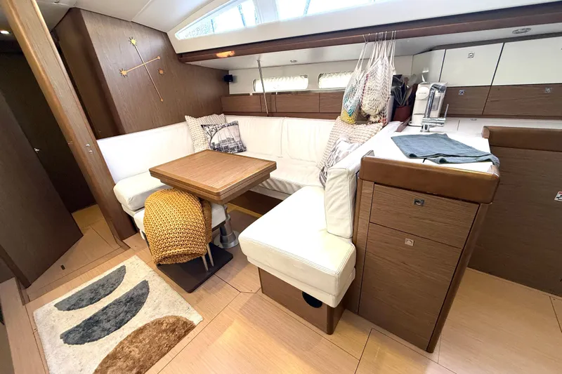 Cruzeiro Do Sul Yacht Photos Pics Luxurious interior of 2013 Jeanneau Sun Odyssey 44 DS sailboat with cozy seating and modern design.