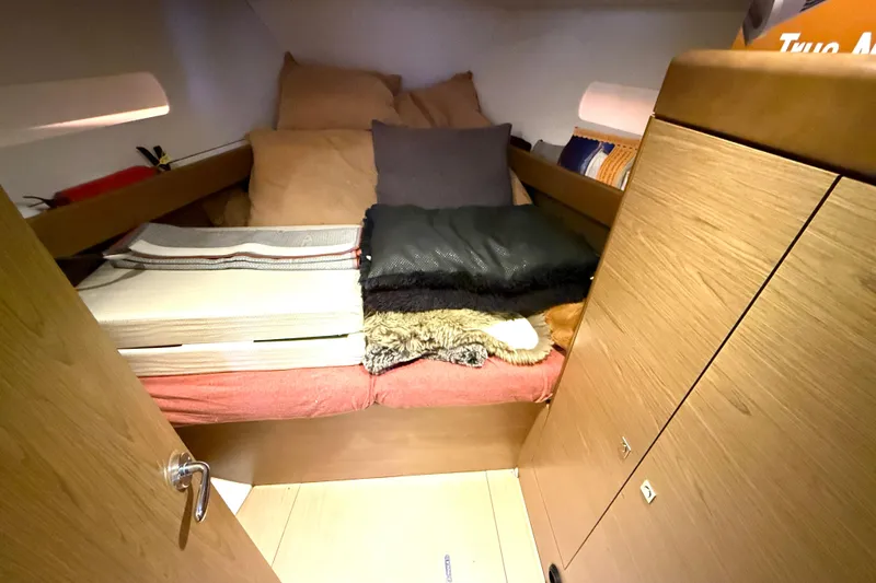 Cruzeiro Do Sul Yacht Photos Pics Cozy cabin interior of 2013 Jeanneau Sun Odyssey 44 DS sailboat with bedding and storage.