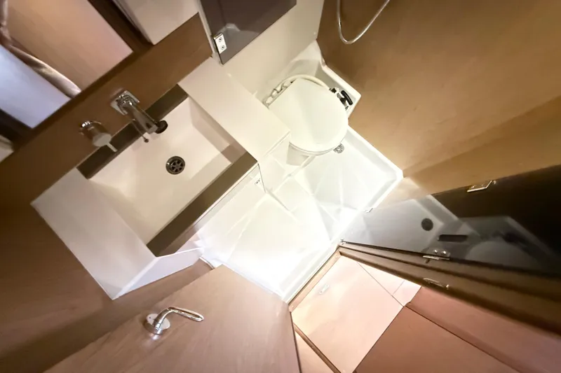 Cruzeiro Do Sul Yacht Photos Pics Bathroom interior of 2013 Jeanneau Sun Odyssey 44 DS yacht, featuring sink and toilet.