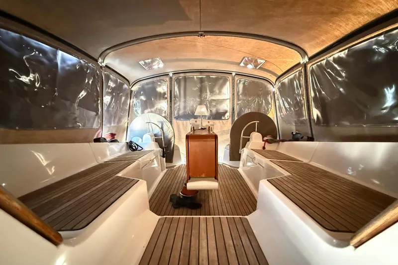 Cruzeiro Do Sul Yacht Photos Pics Interior view of 2013 Jeanneau Sun Odyssey 44 DS sailboat with wooden seating and canopy.