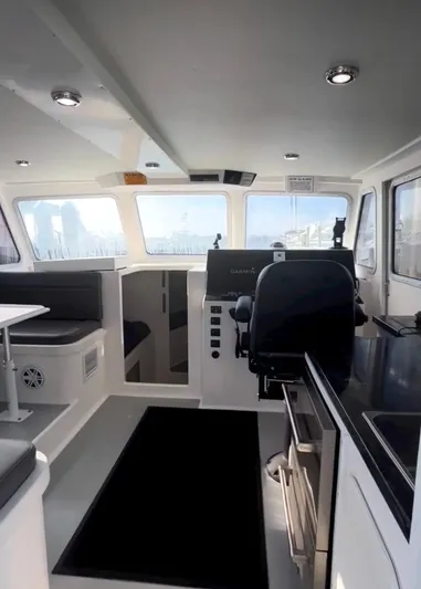 "silver Lining" Yacht Photos Pics Modern boat interior with seating, navigation equipment, and windows, Flowers Down East 2022 model.