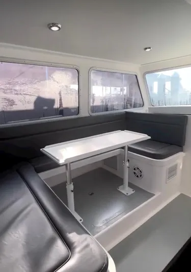 "silver Lining" Yacht Photos Pics Interior of a 2022 Flowers Down East boat with seating and table.