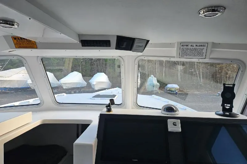 "silver Lining" Yacht Photos Pics Interior view of a 2022 Flowers Down East boat with covered boats outside.