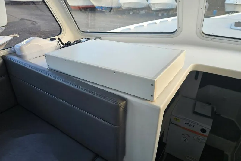 "silver Lining" Yacht Photos Pics Interior of a 2022 Flowers Down East boat with seating and storage.