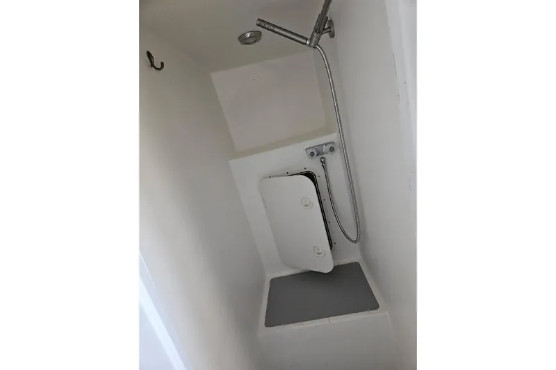 "silver Lining" Yacht Photos Pics Compact white shower area with handheld showerhead and small storage compartment.