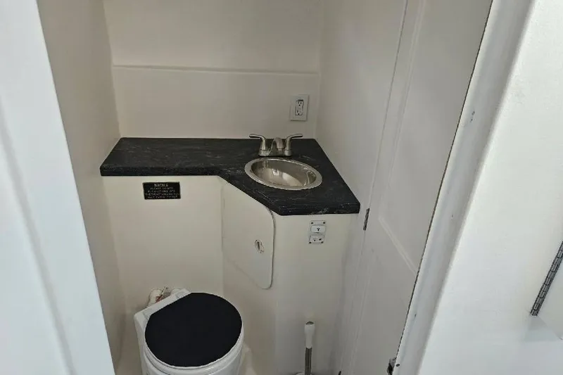 "silver Lining" Yacht Photos Pics Compact bathroom with black countertop, sink, and toilet in a 2022 Flowers Down East model.