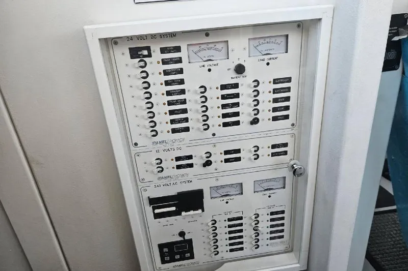 "silver Lining" Yacht Photos Pics Electrical control panel with switches and meters for 24V DC, 12V DC, and 240V AC systems.