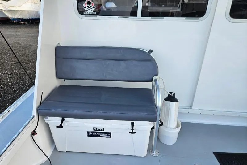 "silver Lining" Yacht Photos Pics Boat interior with cushioned seat on a Yeti cooler, Flowers Down East model, 2022.