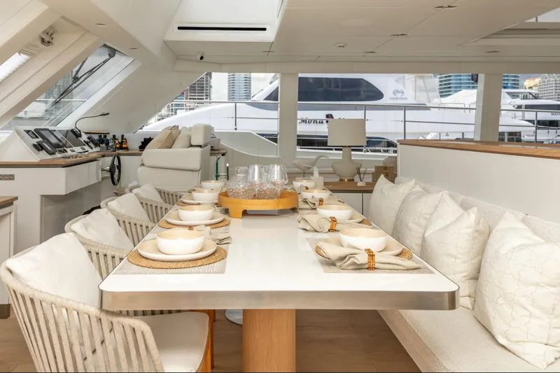 Fat Cat Yacht Photos Pics Luxurious interior of 2024 Sunreef 80 Power yacht with elegant dining setup.