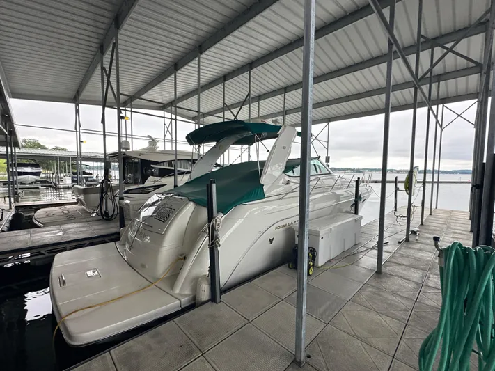  Yacht Photos Pics 2000 Formula 40 PC yacht docked under covered marina with green canopy.
