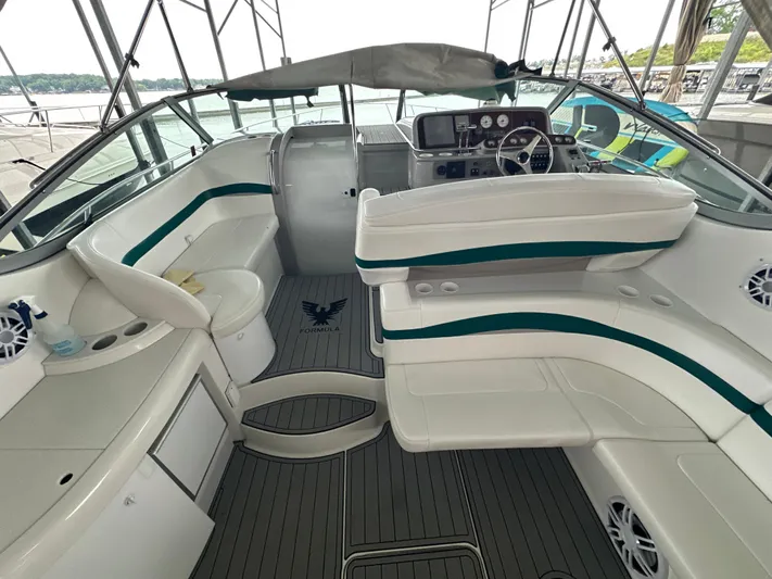  Yacht Photos Pics Interior of 2000 Formula 40 PC boat with white seating and steering console.