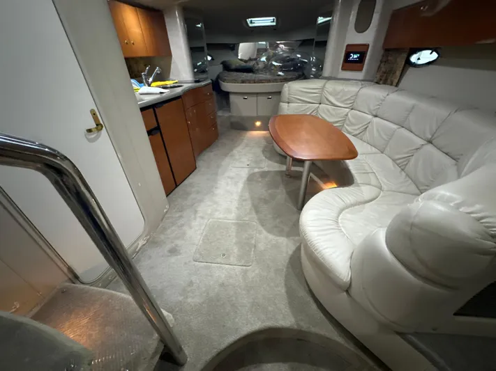  Yacht Photos Pics Interior of a 2000 Formula 40 PC yacht with a cozy seating area and kitchenette.