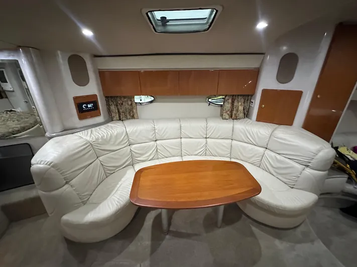  Yacht Photos Pics Interior of 2000 Formula 40 PC yacht with white leather seating and wooden table.