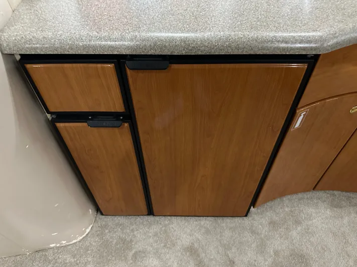  Yacht Photos Pics Wooden cabinet with countertop in a 2000 Formula 40 PC boat interior.