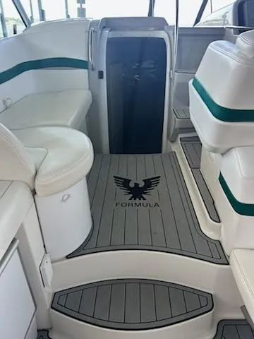  Yacht Photos Pics Interior of a 2000 Formula 40 PC boat with white seating and logo on the floor.