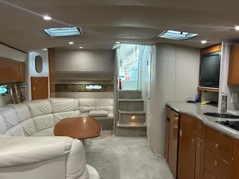  Yacht Photos Pics Interior of 2000 Formula 40 PC yacht with white leather seating and wooden cabinetry.