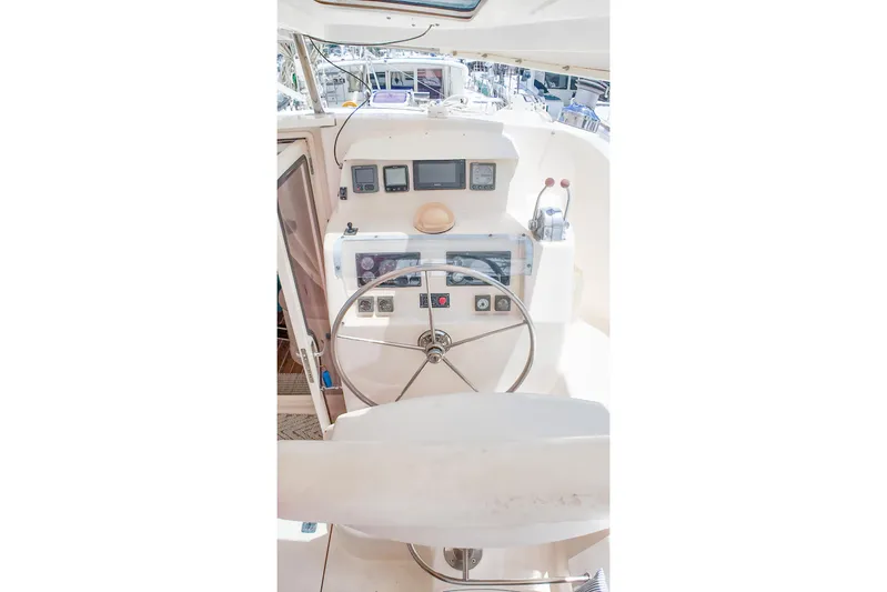 Katara Yacht Photos Pics Helm of 2005 Leopard 43 catamaran with steering wheel and navigation instruments.