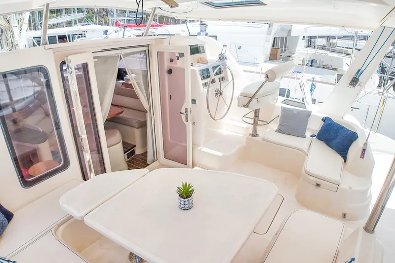 Katara Yacht Photos Pics Luxurious 2005 Leopard 43 yacht interior with seating, helm, and table.