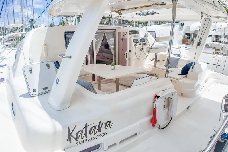 Katara Yacht Photos Pics 2005 Leopard 43 catamaran with spacious deck and seating, docked in a marina.