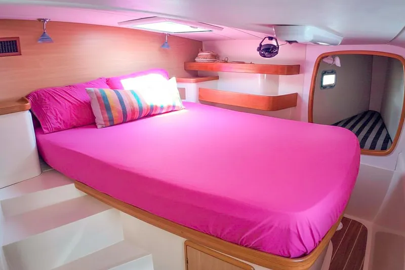 Katara Yacht Photos Pics Cozy cabin interior of 2005 Leopard 43 yacht with vibrant pink bedding.
