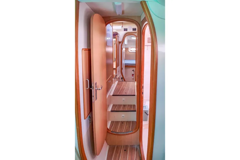Katara Yacht Photos Pics Interior of 2005 Leopard 43 yacht, featuring wooden doors and steps.