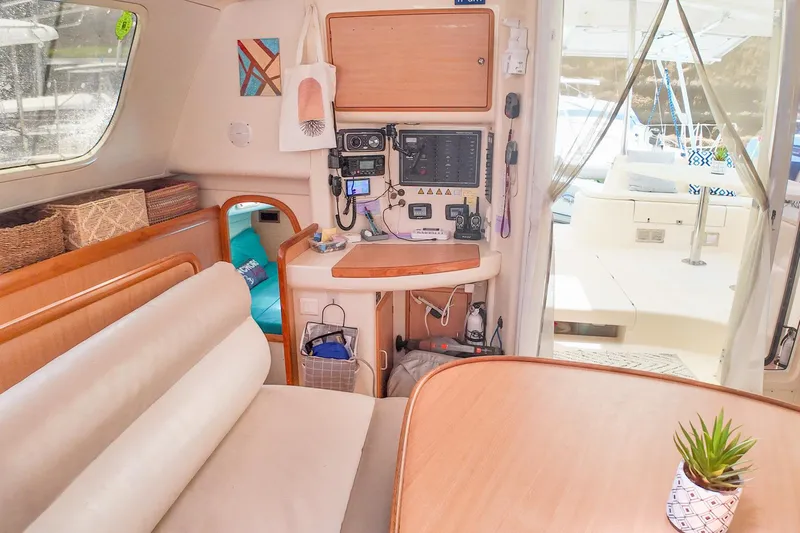 Katara Yacht Photos Pics Interior of a 2005 Leopard 43 catamaran with navigation equipment and cozy seating area.