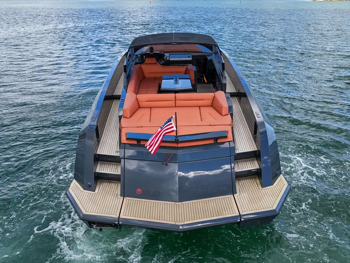  Yacht Photos Pics Luxury 2020 Vanquish VQ58 yacht with spacious deck and American flag on water.