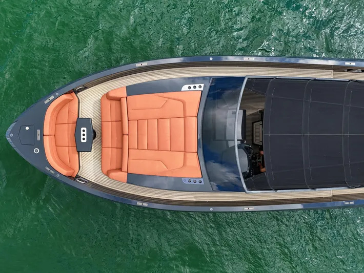  Yacht Photos Pics Aerial view of 2020 Vanquish VQ58 yacht with orange seating on green water.