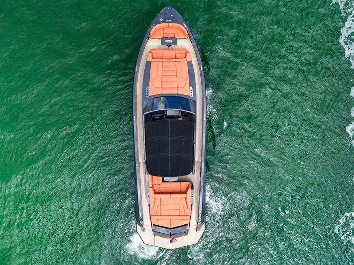  Yacht Photos Pics Aerial view of 2020 Vanquish VQ58 yacht cruising on vibrant green water.