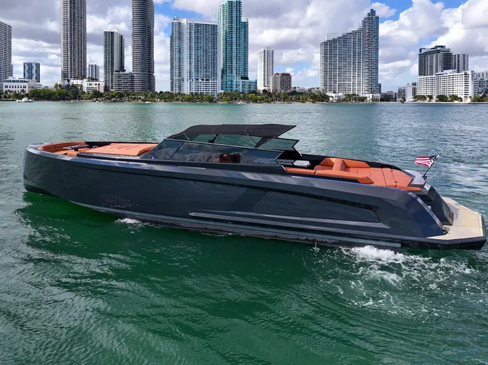  Yacht Photos Pics 2020 Vanquish VQ58 yacht cruising near city skyline on a sunny day.