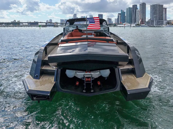  Yacht Photos Pics Luxury 2020 Vanquish VQ58 yacht on water with city skyline backdrop.