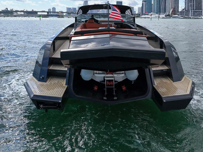 Yacht Photos Pics 2020 Vanquish VQ58 luxury yacht on water, rear view with city skyline.