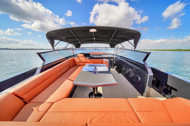  Yacht Photos Pics Luxurious 2020 Vanquish VQ58 yacht with orange seating and sleek design on open water.