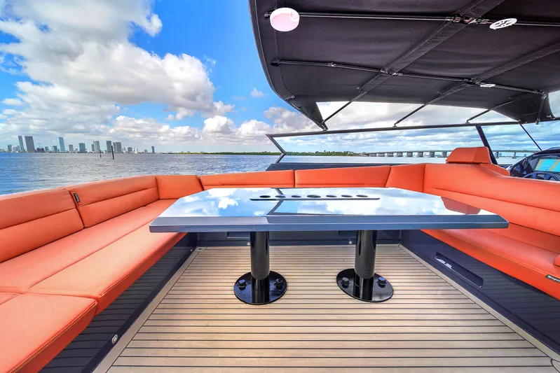  Yacht Photos Pics Luxurious 2020 Vanquish VQ58 yacht with spacious deck and orange seating, city skyline view.