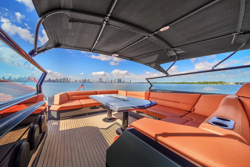  Yacht Photos Pics Luxurious 2020 Vanquish VQ58 yacht interior with orange seating and city skyline view.