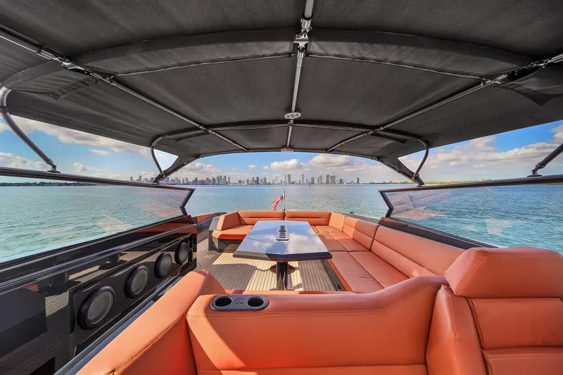  Yacht Photos Pics Luxurious 2020 Vanquish VQ58 yacht interior with orange seating and ocean view.