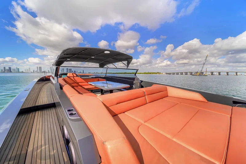  Yacht Photos Pics Luxurious 2020 Vanquish VQ58 yacht with spacious deck and seating, under a vibrant sky.