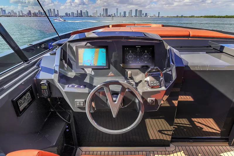  Yacht Photos Pics Cockpit of 2020 Vanquish VQ58 yacht with city skyline in background.