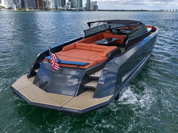  Yacht Photos Pics Luxury 2020 Vanquish VQ58 yacht cruising on water with city skyline backdrop.