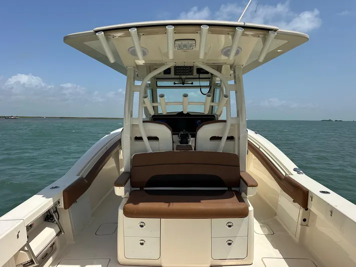  Yacht Photos Pics 2015 Scout 350 LXF boat interior with seating, ocean view, and clear sky.