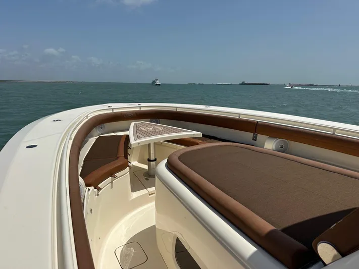  Yacht Photos Pics 2015 Scout 350 LXF boat with brown seating and table on open water.