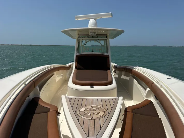  Yacht Photos Pics 2015 Scout 350 LXF boat interior with brown seating, wooden deck, and ocean view.