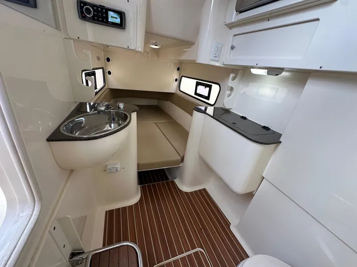  Yacht Photos Pics 2015 Scout 350 LXF cabin interior with sink, seating, and wood flooring.
